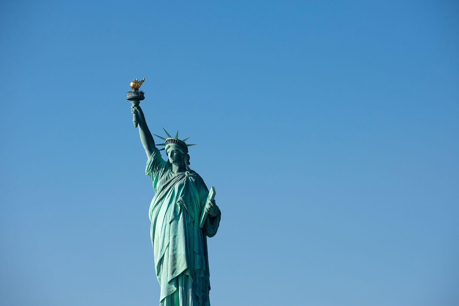The Statue of Liberty surrounded by blue sky