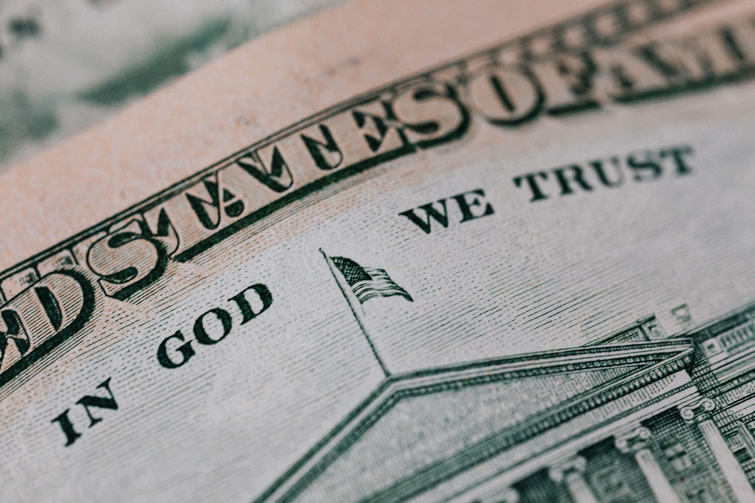 Close up of United States dollar bill showing the words: "In God We Trust"