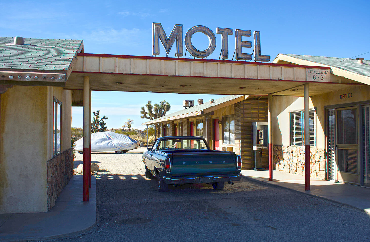 Old style Motel with vintage Ford pickup truck parked at the entrance