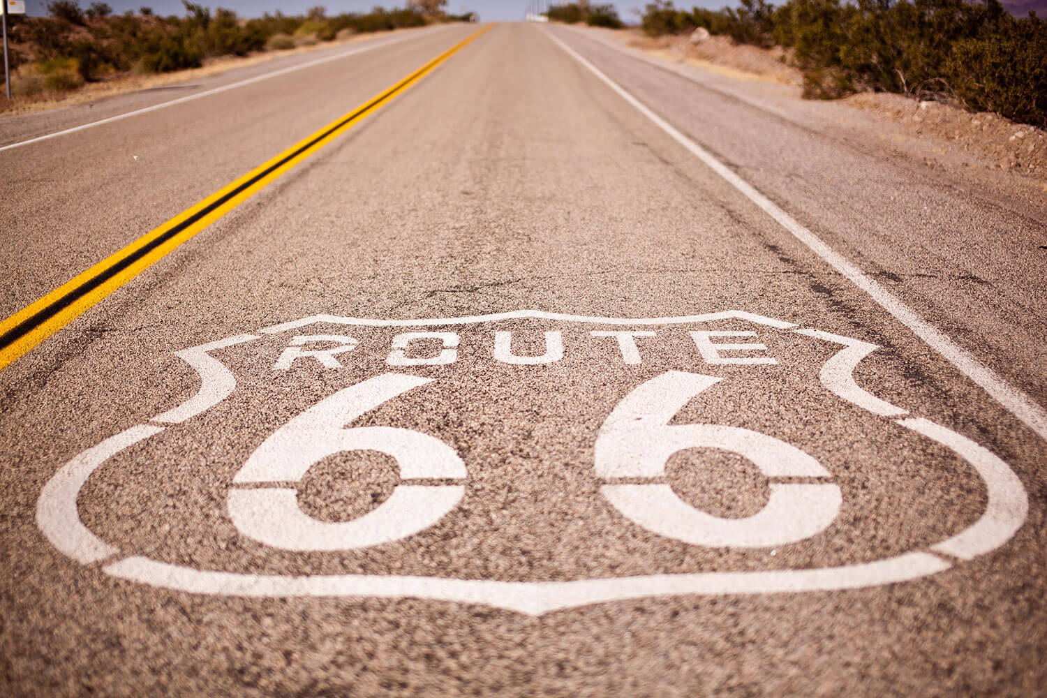 Route 66 road marking with highway trailing off into the distance