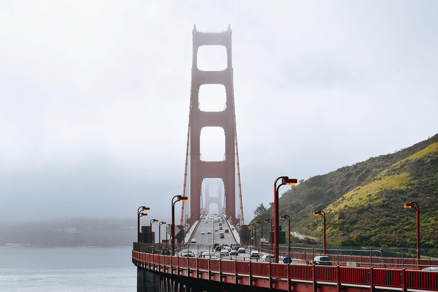 Looking directly down the Golden Gate Bridge surrounded in a light mist