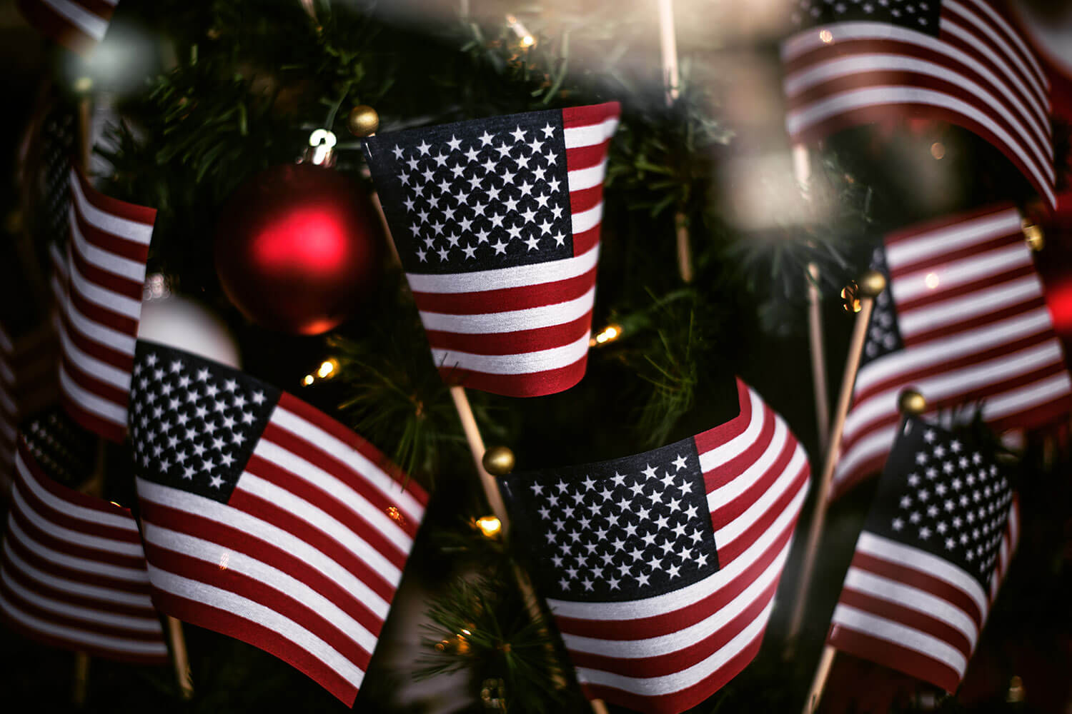 Closeup shot of small US flags on a Christmas tree