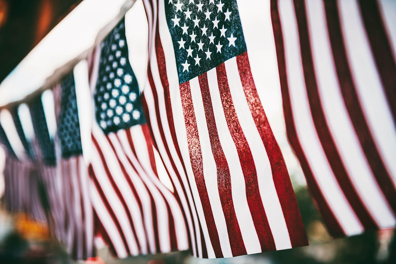 American flags hanging down vertically in a row